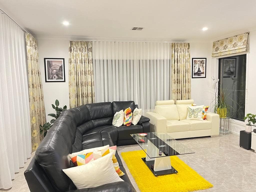 Patterned drapes layered with sheers in a living room