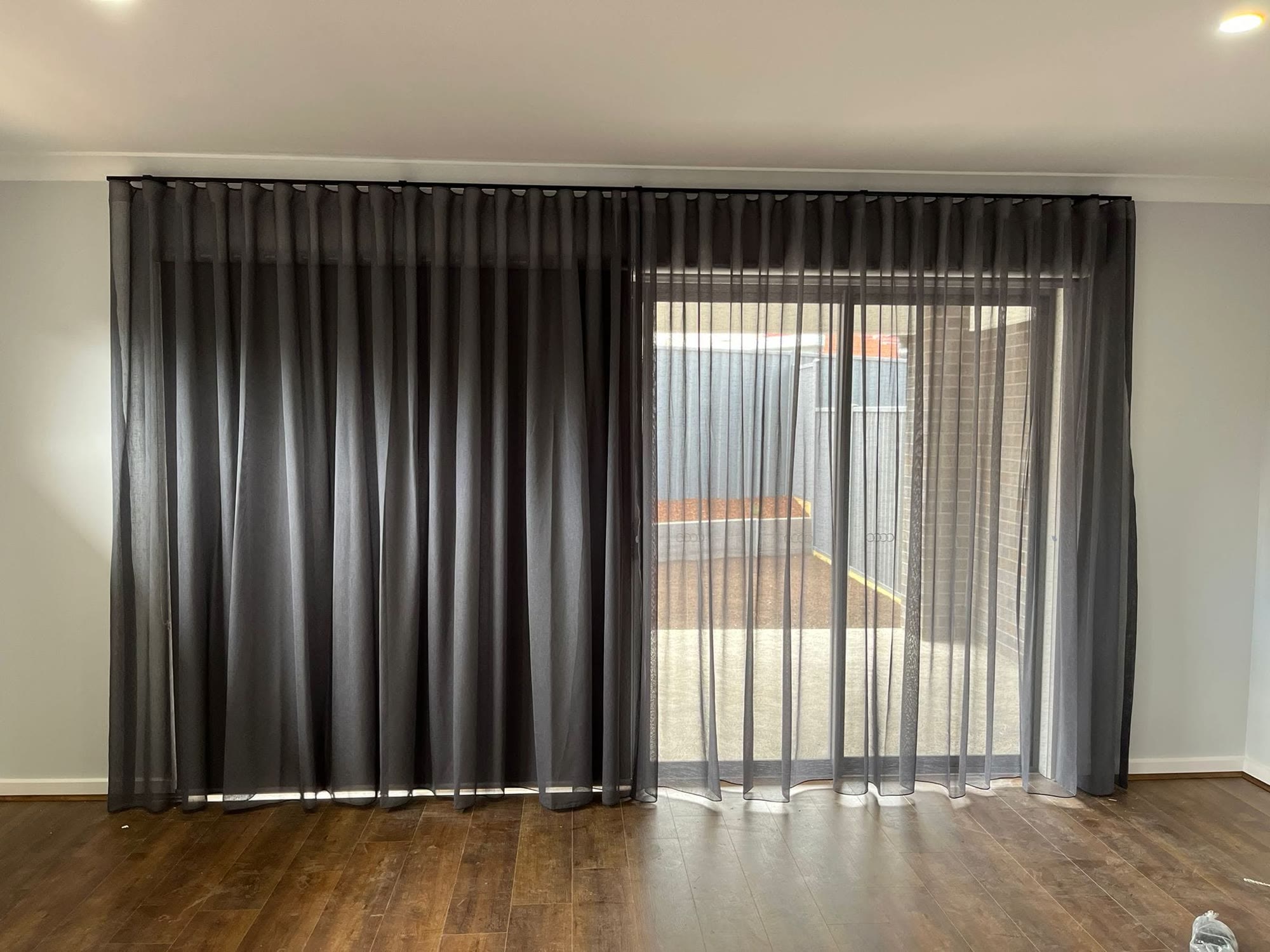 Charcoal sheer curtains on a sliding door