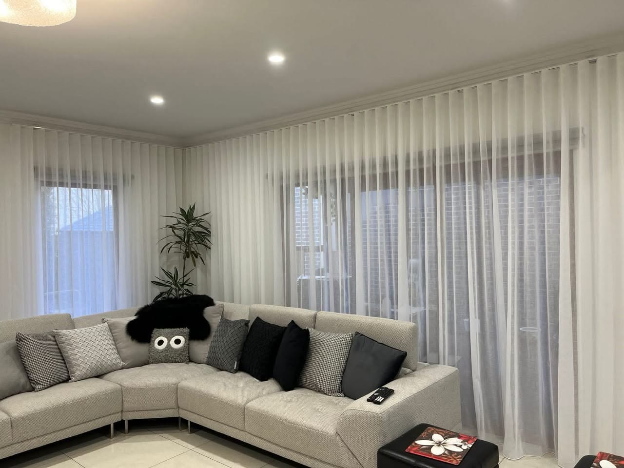 Sheer curtains wrapping the corner windows of a lounge