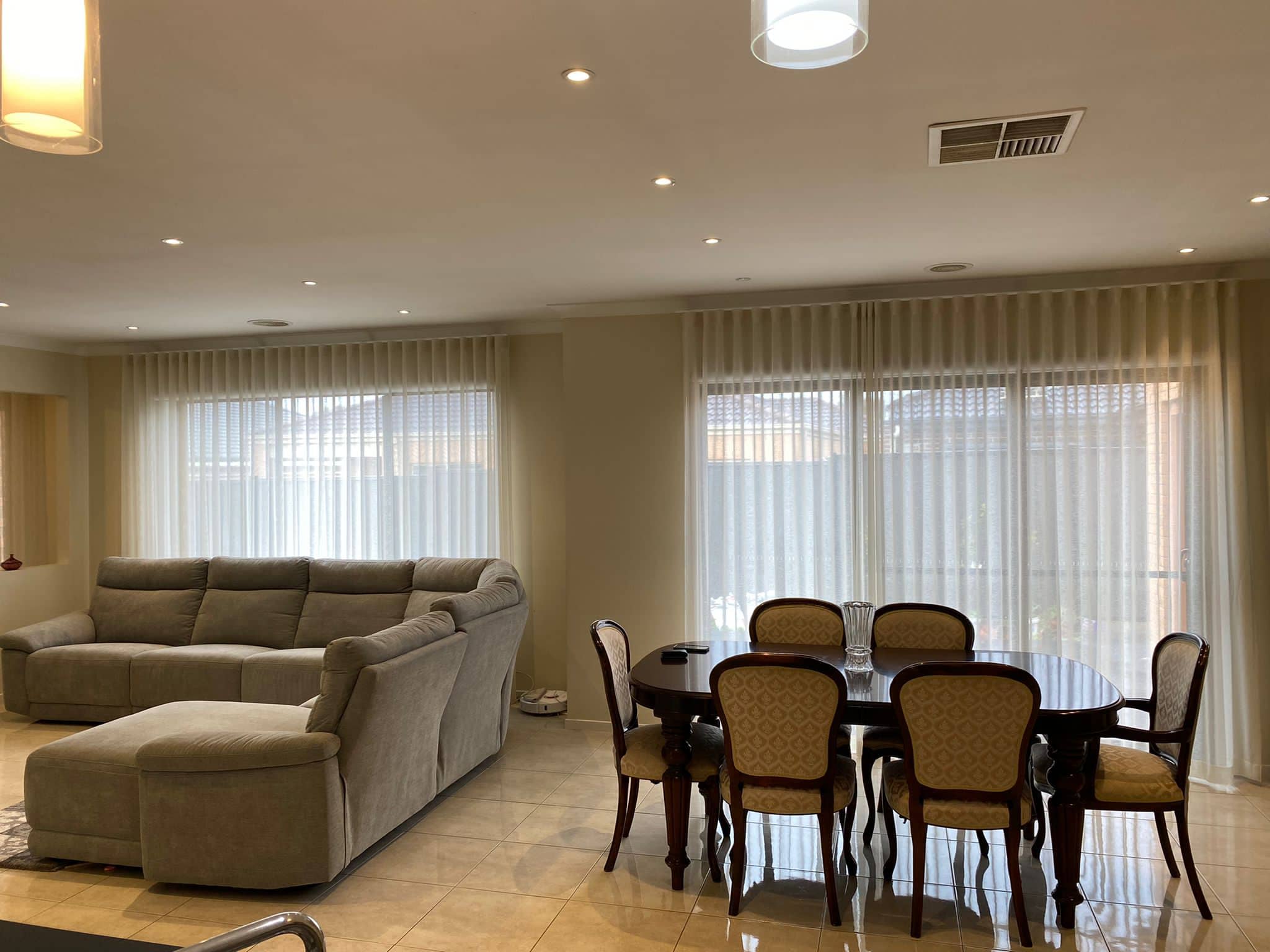 Sheer curtains behind a leather lounge