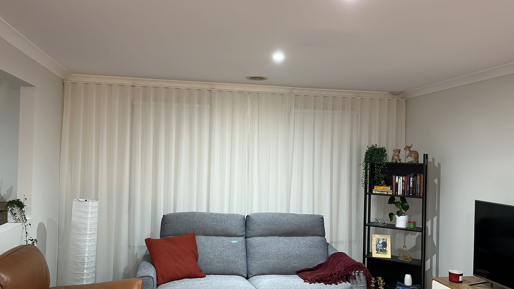 Grey S-fold sheer curtains in a family room