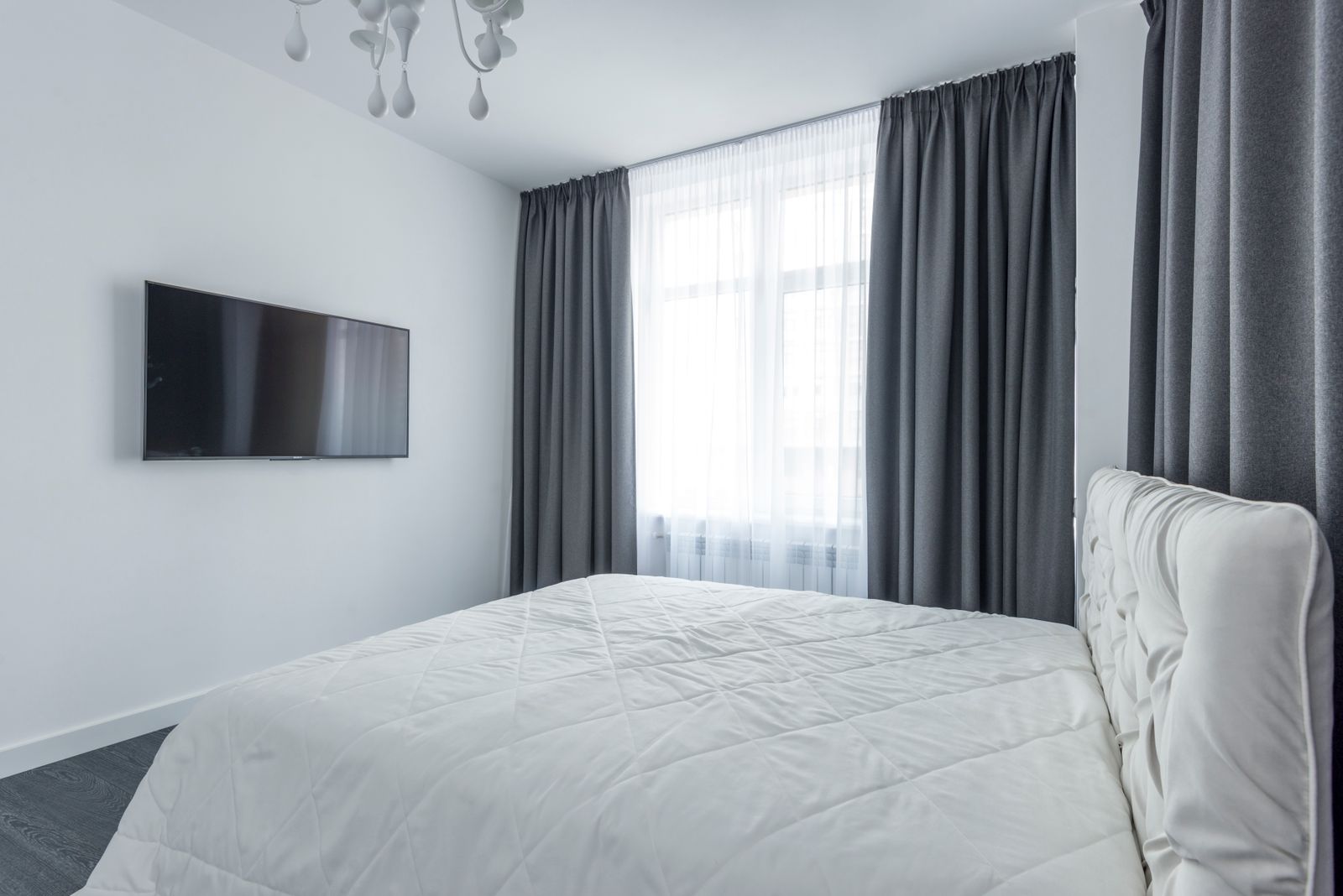 Charcoal curtains framing a sheer-dressed window