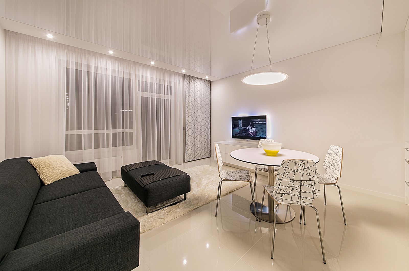 Floor-to-ceiling sheer curtains in a bright living room